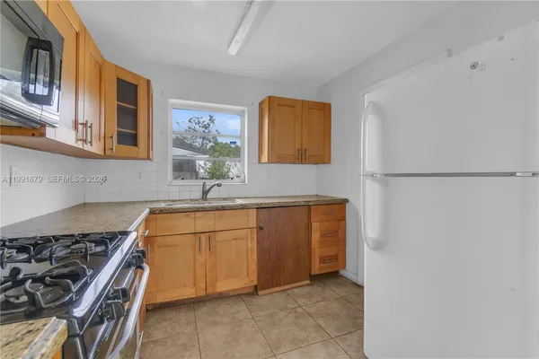 a kitchen with stainless steel appliances granite countertop a sink and a stove top oven