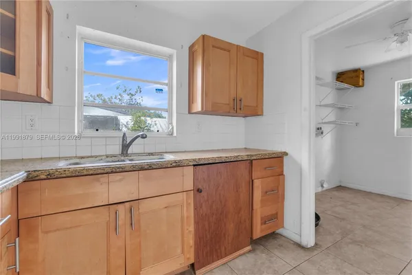 a kitchen with stainless steel appliances granite countertop a sink and a cabinets