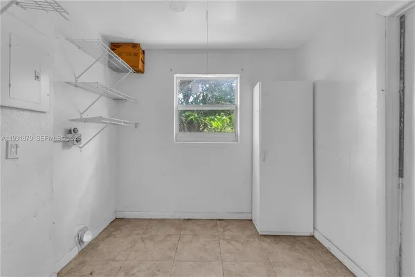 a view of a kitchen with fridge and a sink