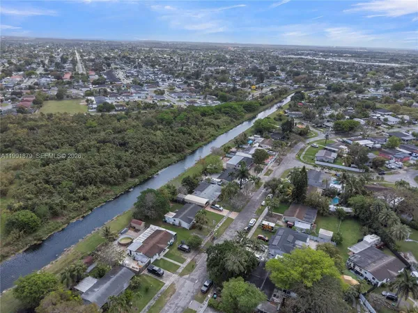 an aerial view of a house with a yard and lake view