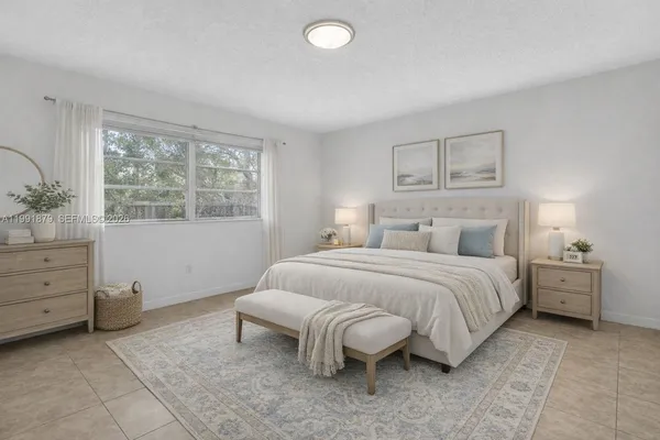 a bedroom with a bed and window