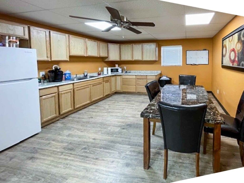 3050 Highway 17 Pecos, TX 79772 - Photo 15 of 22 a kitchen with a refrigerator a stove a sink dishwasher with a dining table and chairs