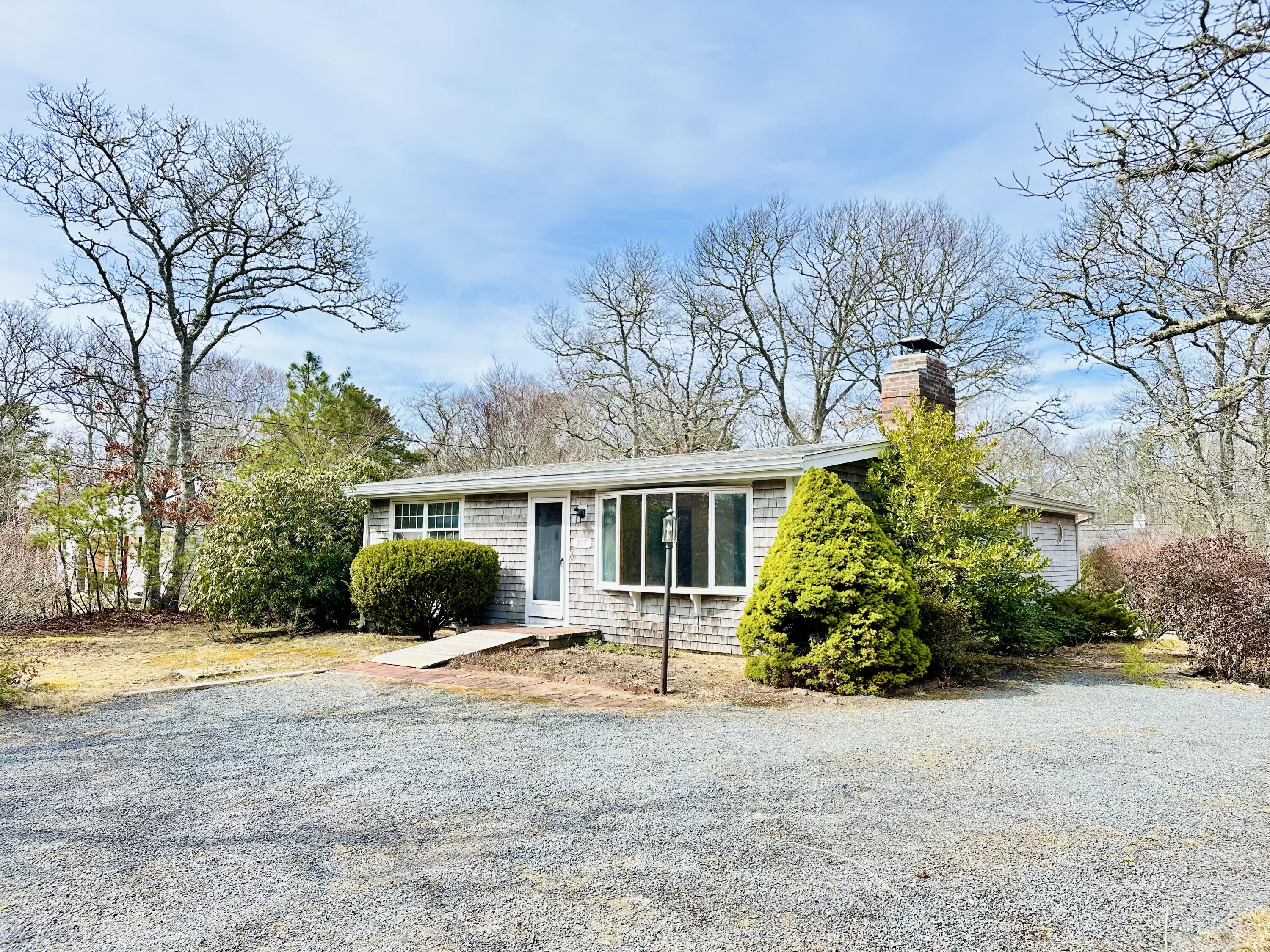 217 Freemans Way Brewster, MA 02631 - Photo 4 of 57 a front view of house with yard and green space