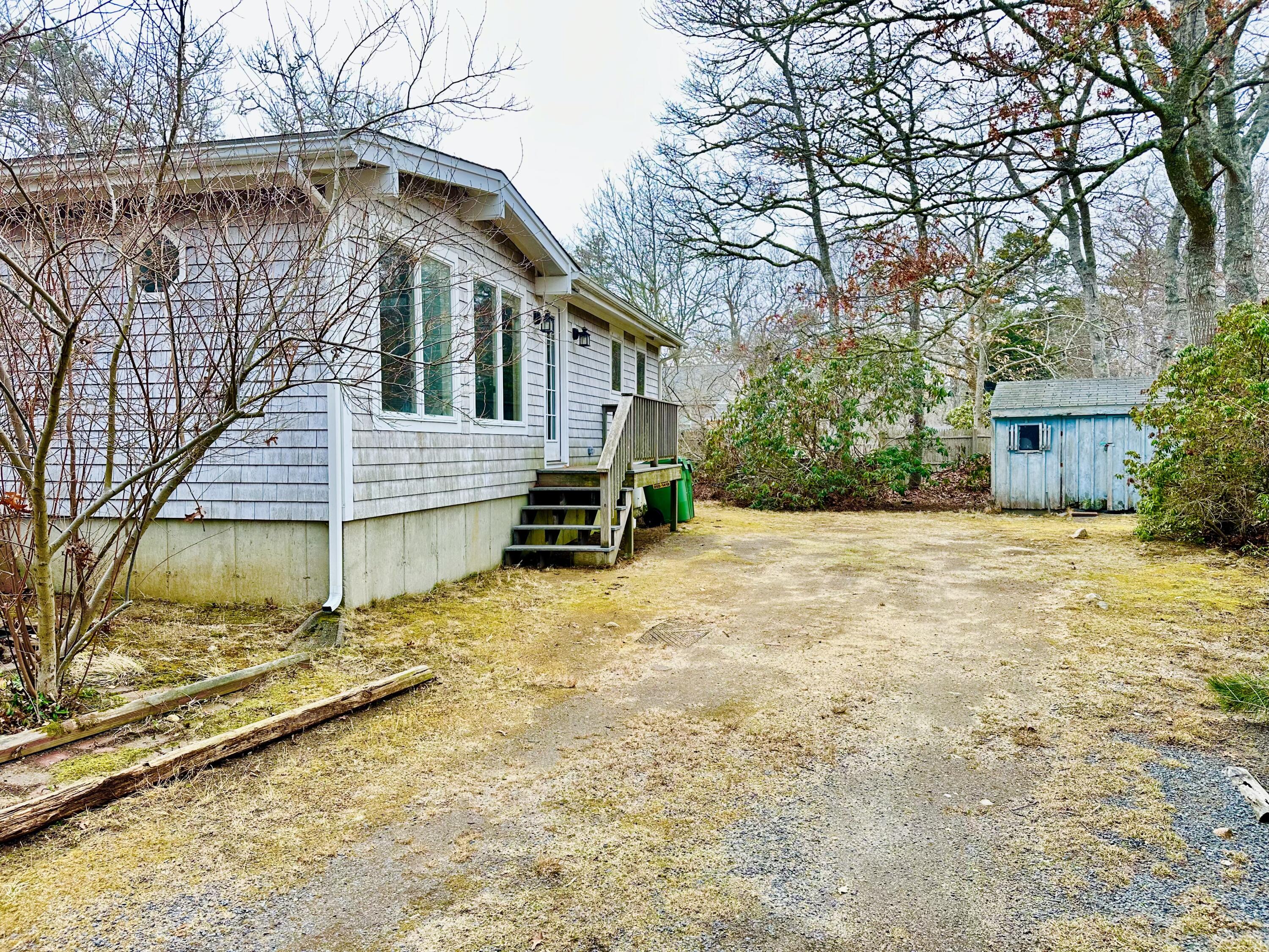 217 Freemans Way Brewster, MA 02631 - Photo 48 of 57 a view of a house with a yard