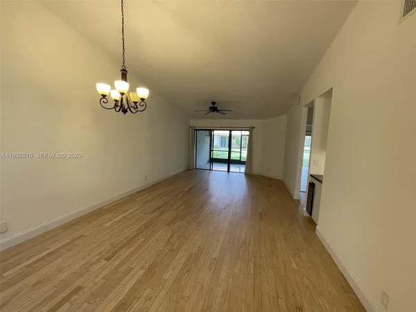 a view of livingroom and kitchen with wooden floor