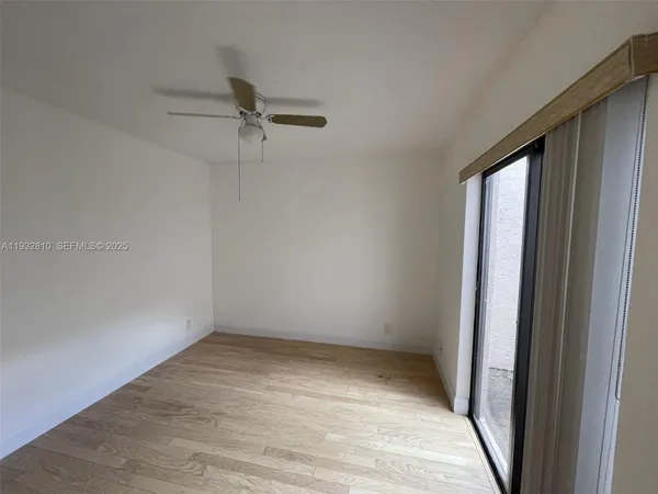 a view of room with window and hardwood floor
