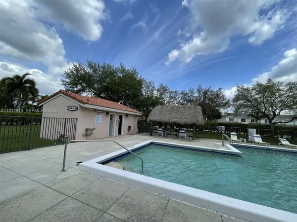 a view of a house with a big yard and large tree