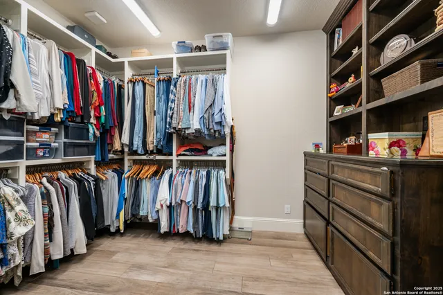 a bedroom with a bed a couch and a painting on the wall