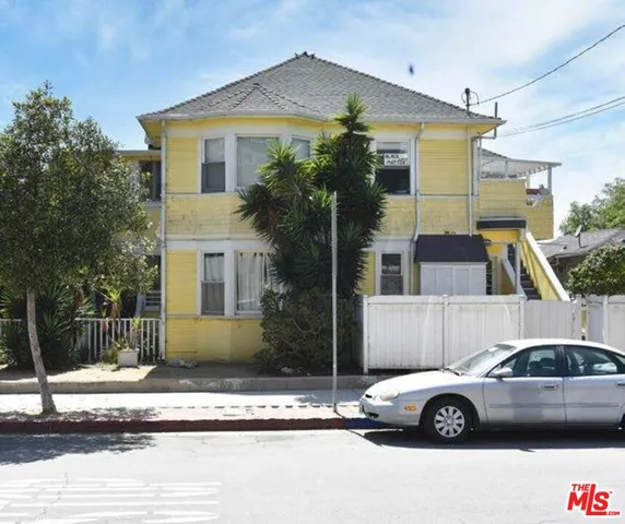 a front view of a house with parking space