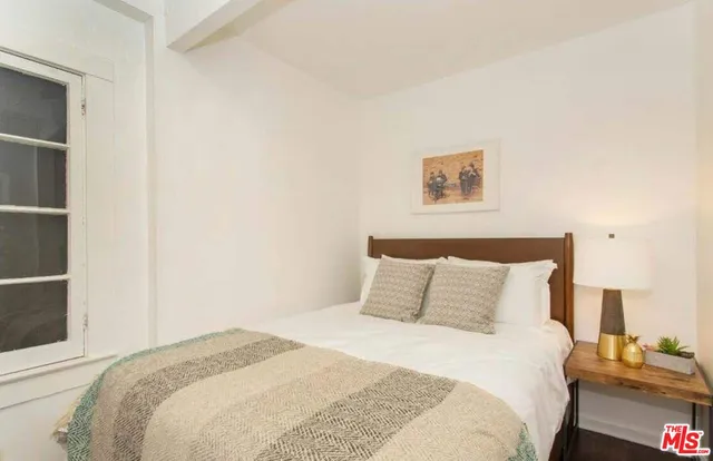 a bedroom with a bed and a lamp