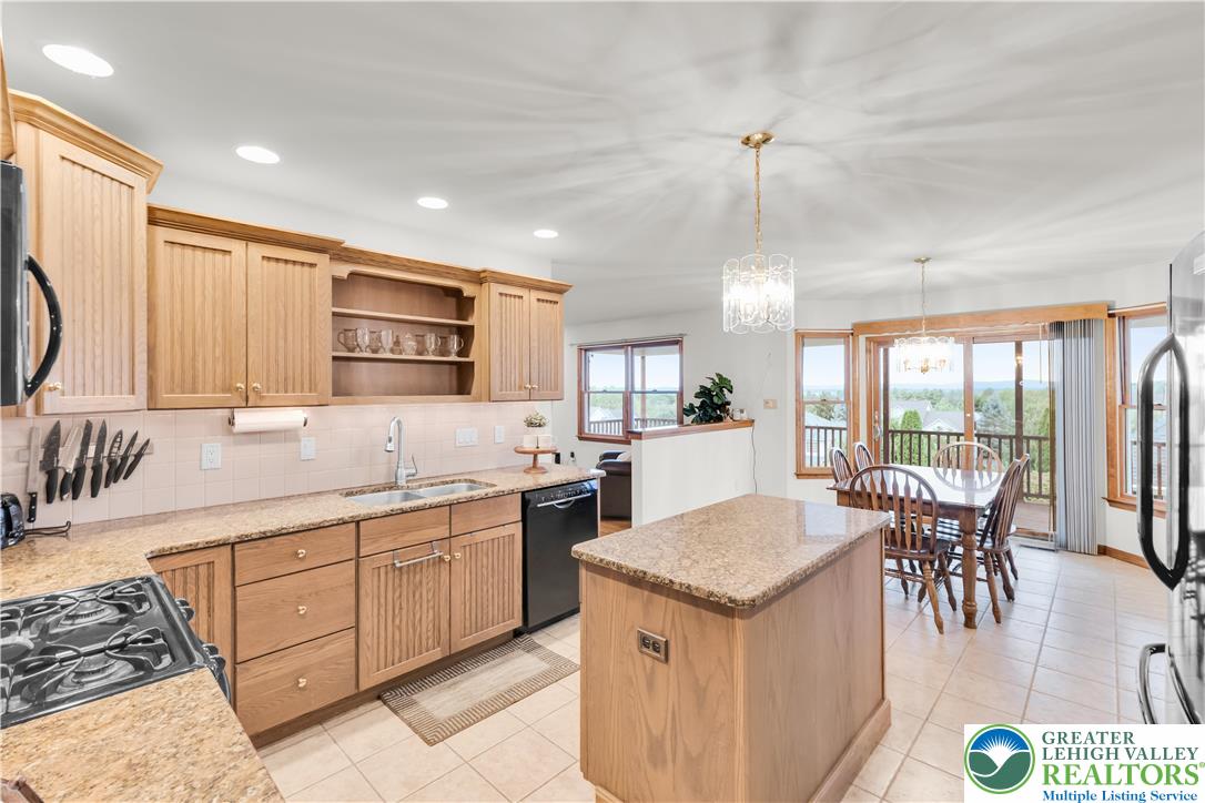 461 East Beil Avenue Nazareth, PA 18064 - Photo 17 of 64 a kitchen with a stove a sink a kitchen island with chairs and wooden floor