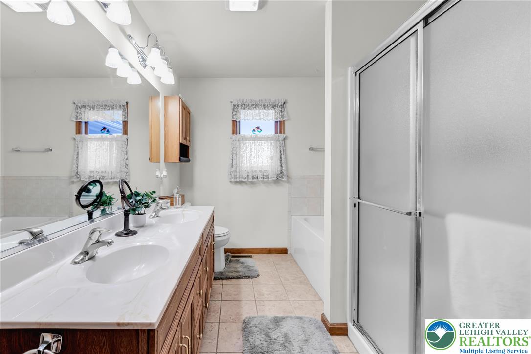 461 East Beil Avenue Nazareth, PA 18064 - Photo 31 of 64 a bathroom with a sink a mirror and a shower