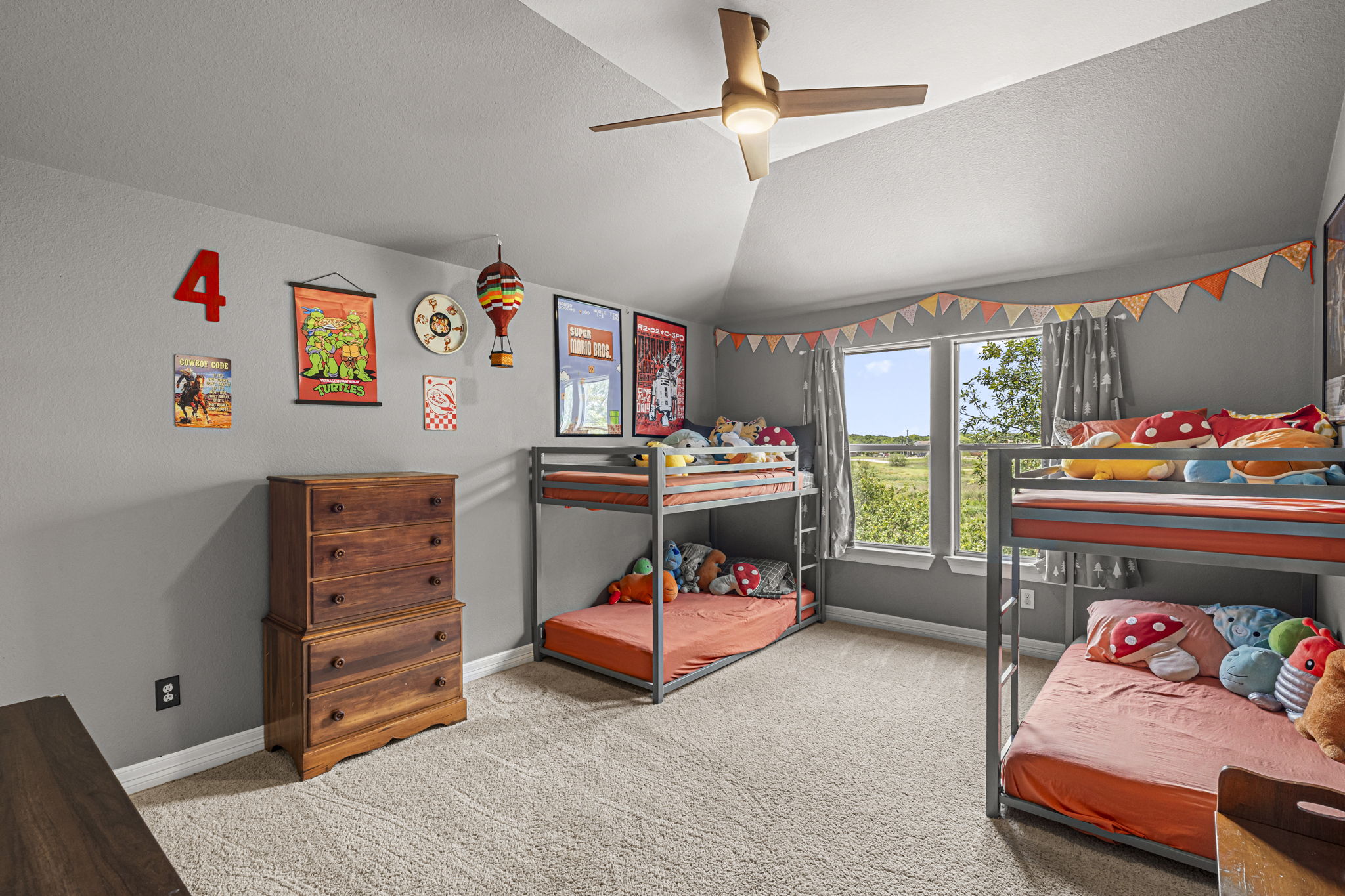 454 Fall Circle Kyle, TX 78640 - Photo 32 of 39 This cozy bedroom offers bunk beds, plush carpeting, and a modern ceiling fan, creating a comfortable and inviting atmosphere.