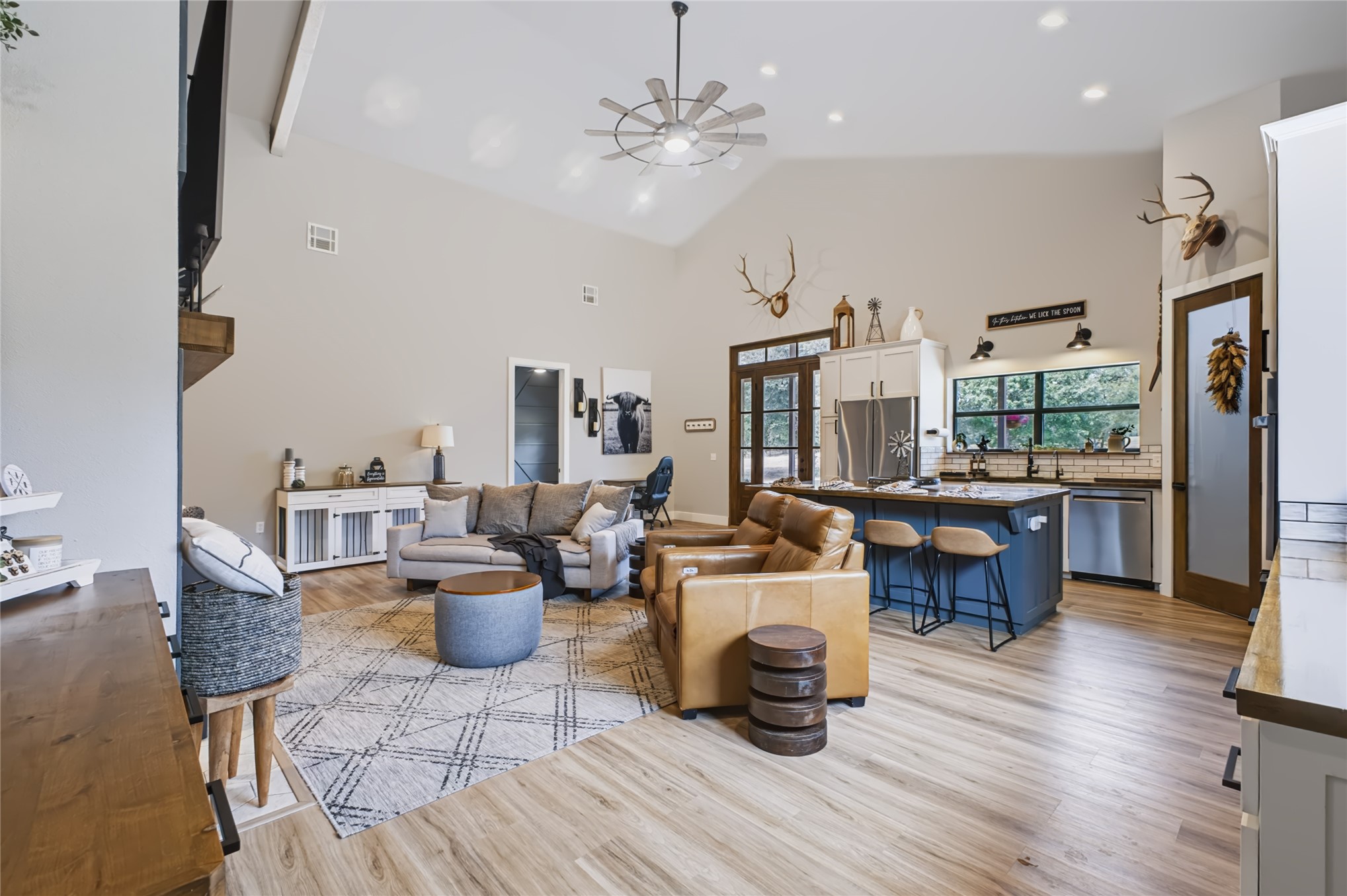 3607 South Half Bank Road Atoka, OK 74525 - Photo 25 of 82 Vaulted ceilings, wood-finish flooring, kitchen island with seating, stainless steel appliances, and abundant natural light