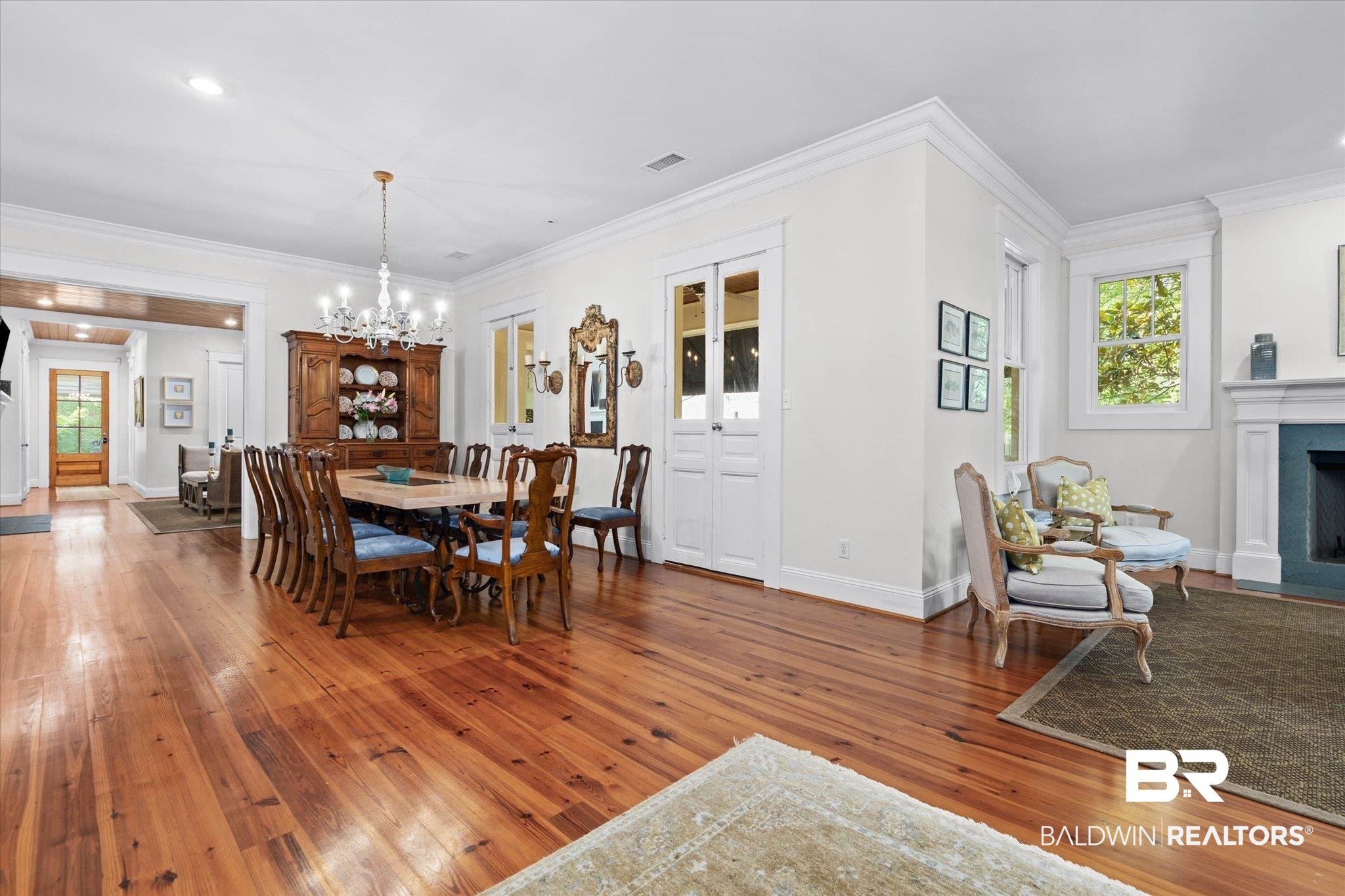 3813 Austill Lane Mobile, AL 36608 - Photo 3 of 37 Bright dining area featuring wood-finish flooring, a chandelier, and ample natural light from multiple windows