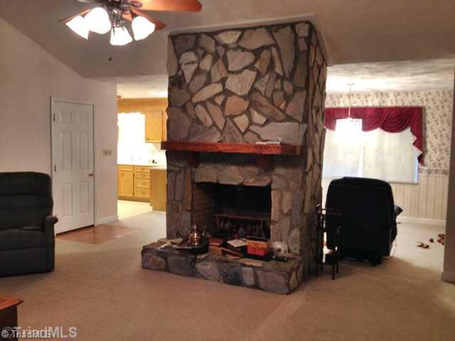 501 Ridgeway Lane Lexington, NC 27295 - Photo 3 of 16 Living Room. Beautiful wood-burning stone fireplace divides living room from dining area.