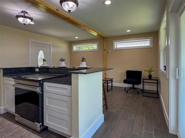 a kitchen with a sink cabinets and wooden floor