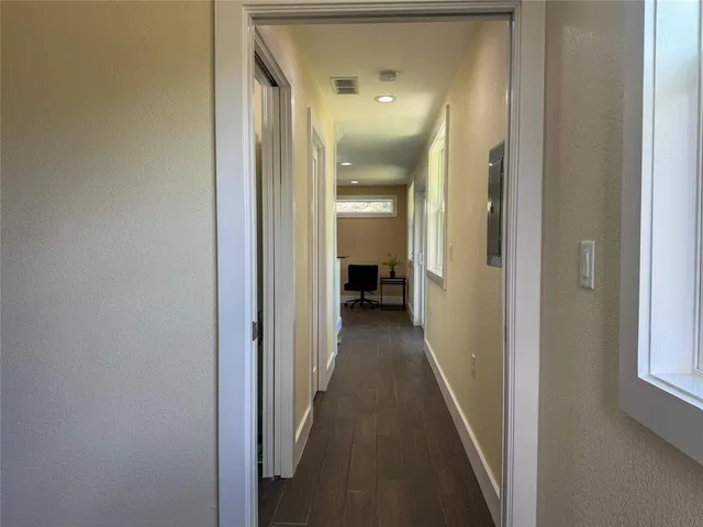 a view of a hallway with a wooden door