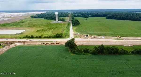 a view of a field with an ocean beach