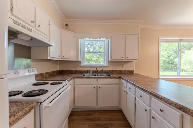 a kitchen with appliances cabinets and a window