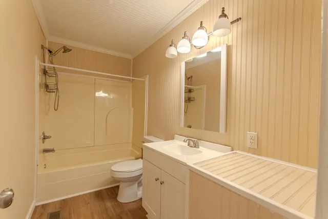 a bathroom with a granite countertop sink toilet a shower and a mirror