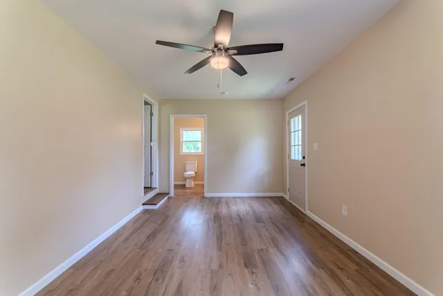 wooden floor in an empty room with a window
