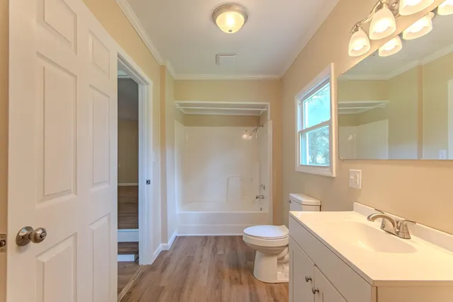 a bathroom with a sink a toilet a tub and shower