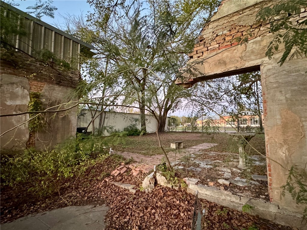 720 South Main Calvert, TX 77837 - Photo 22 of 22 a view of a yard with plants and large trees