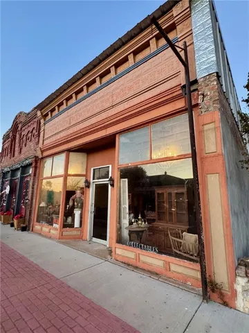 a view of living room with furniture and a floor to ceiling window
