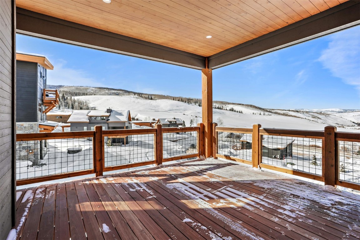 62 Vendette Road Silverthorne, CO 80498 - Photo 25 of 35 a view of a balcony with floor to ceiling windows with wooden floor