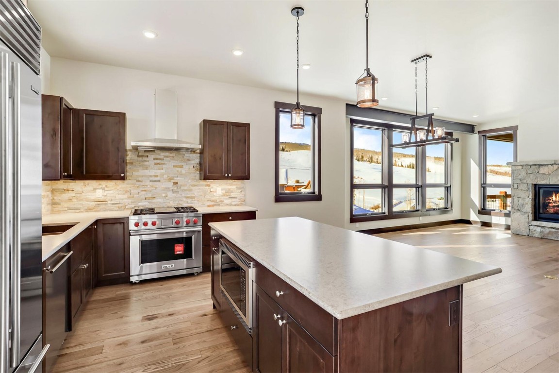 62 Vendette Road Silverthorne, CO 80498 - Photo 7 of 35 a kitchen with stainless steel appliances granite countertop a sink a stove and a wooden floor