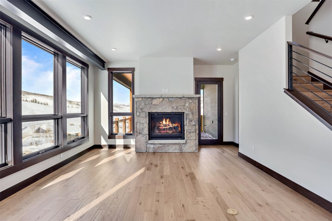 62 Vendette Road Silverthorne, CO 80498 - Photo 8 of 35 a view of an empty room with wooden floor fireplace and a window