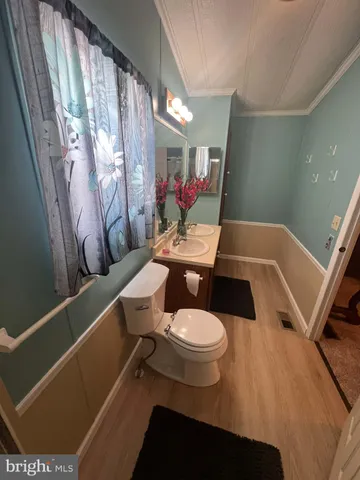 a bathroom with a toilet a sink and a mirror