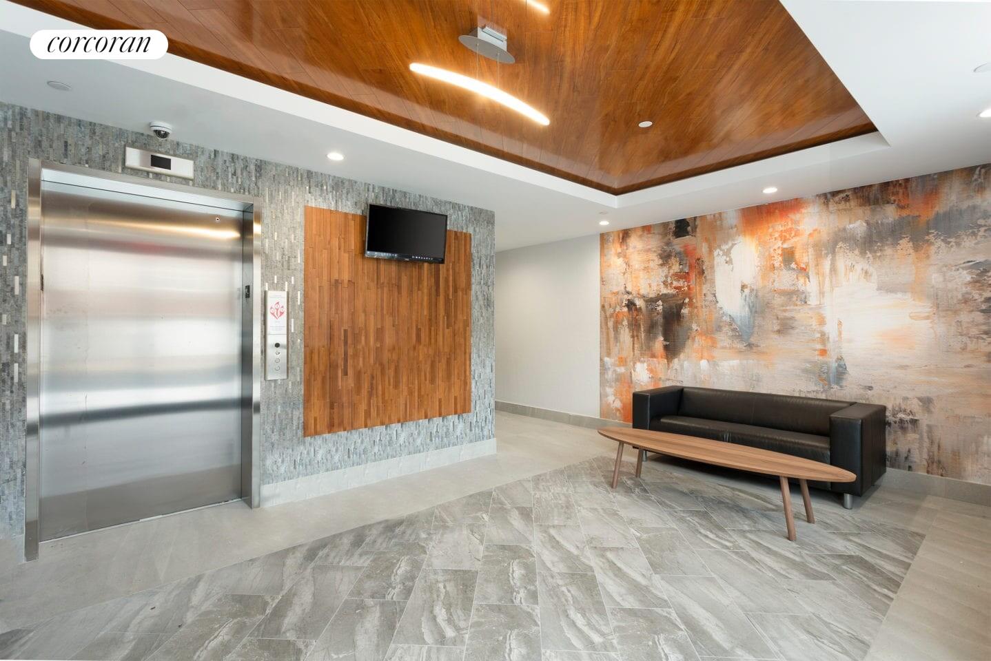 31-10 28th Road, Unit A1 Queens, NY 11102 - Photo 8 of 10 a view of front door with furniture and a shower