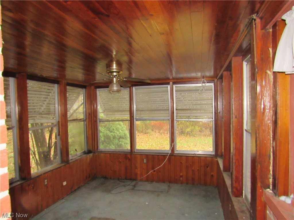 2350 North Taylor Road Cleveland, OH 44112 - Photo 10 of 24 Unfurnished sunroom featuring wooden ceiling and ceiling fan