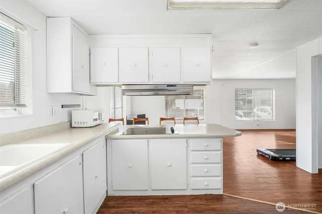 a bedroom with a bed and a wooden floor