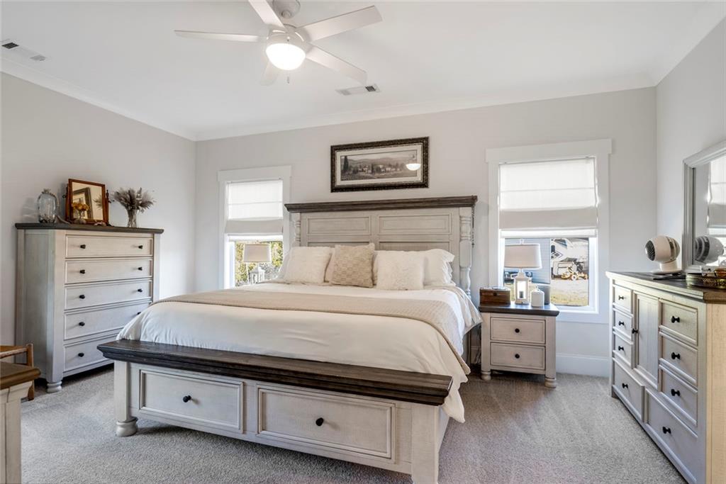 564 Old Airport Road Commerce, GA 30530 - Photo 24 of 39 a bedroom with a bed and a chandelier