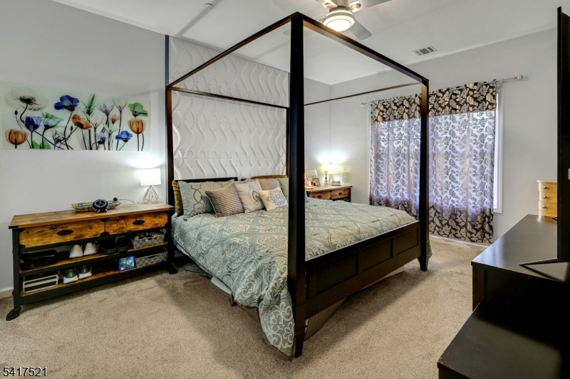 16 Main Street, Unit D6 Sparta, NJ 07871 - Photo 16 of 37 a bed room with a bed and a couch