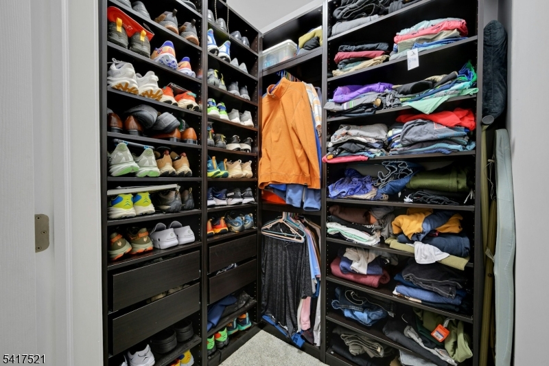 16 Main Street, Unit D6 Sparta, NJ 07871 - Photo 19 of 37 a view of walk in closet with clothes and shoes