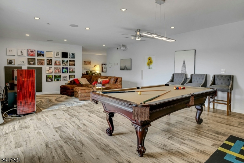 16 Main Street, Unit D6 Sparta, NJ 07871 - Photo 26 of 37 a living room with furniture a table and kitchen view
