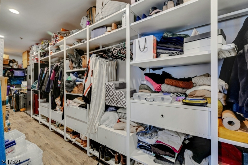 16 Main Street, Unit D6 Sparta, NJ 07871 - Photo 27 of 37 a view of walk in closet with clothes and shoes