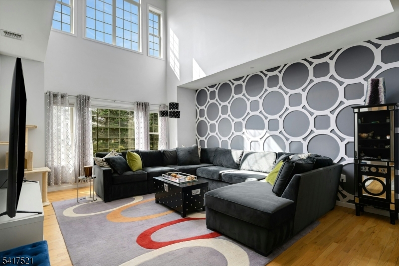 16 Main Street, Unit D6 Sparta, NJ 07871 - Photo 6 of 37 a living room with furniture and a flat screen tv