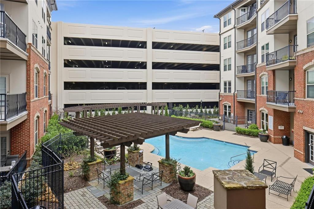 901 Abernathy Road Northeast, Unit 3080 Atlanta, GA 30328 - Photo 1 of 21 a terrace with outdoor seating and wooden floor