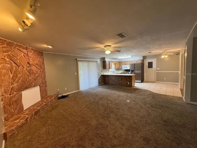 a view of a livingroom with furniture and a kitchen