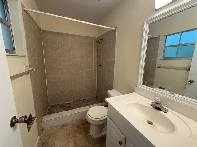 a bathroom with a sink toilet and shower