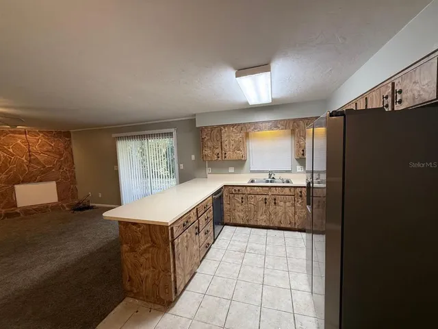 a large kitchen with a stove and a refrigerator