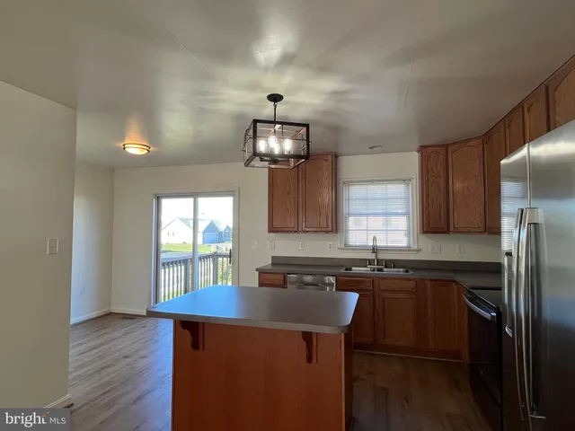 a view of a room with wooden floor and window