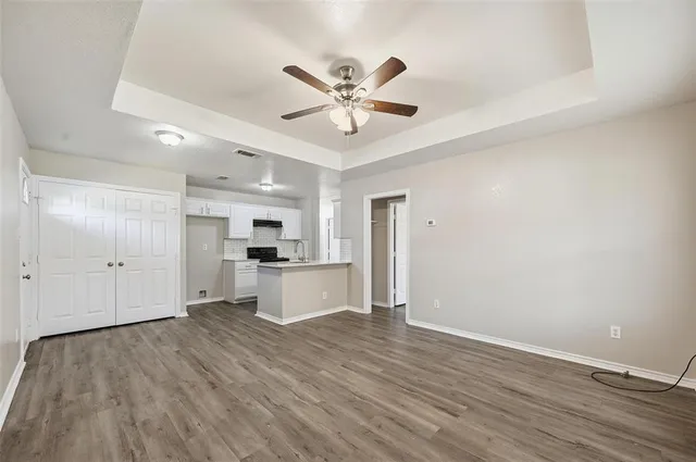 a view of kitchen with refrigerator microwave and wooden floor