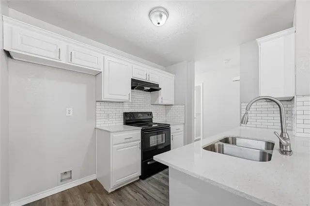a kitchen with a sink a stove and refrigerator
