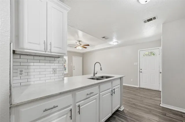 a kitchen with a sink and cabinets